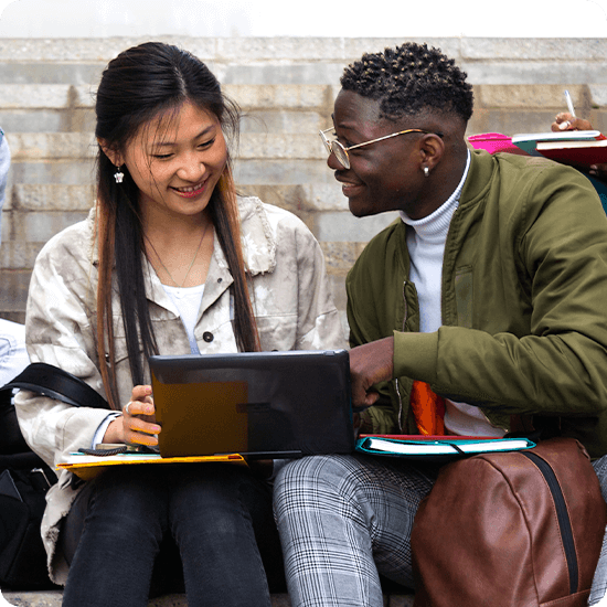 Students talking over a laptop