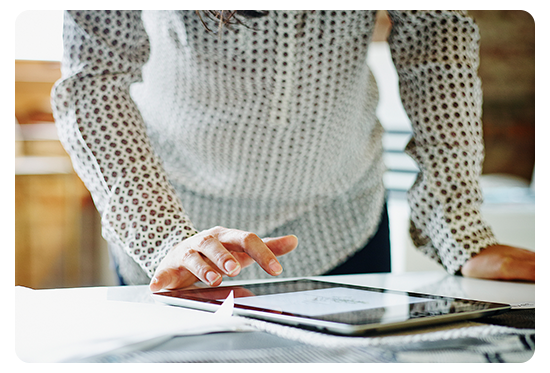 Person standing over tablet
