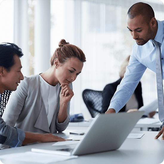 Several people in an office setting discussing a project