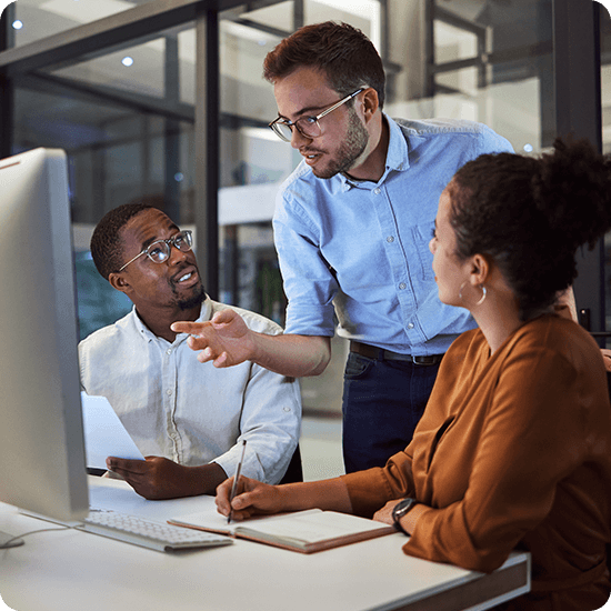 Several people in an office discussing a project