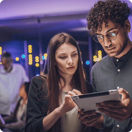 Two people looking at a tablet