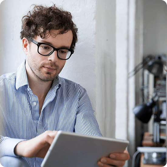 A man typing on a tablet
