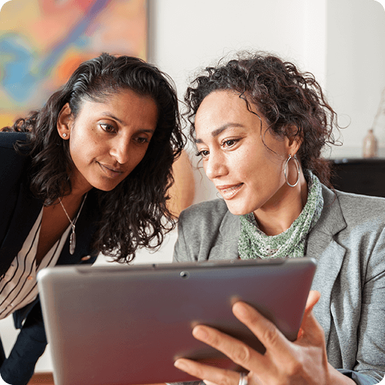 Two women looking at a tablet screen