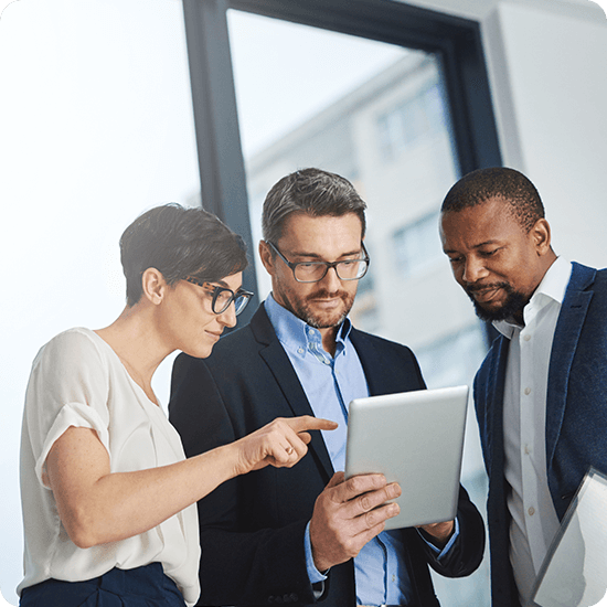 Several people in an office looking at a tablet screen