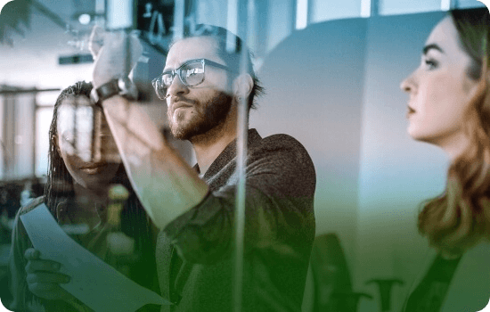 A man and woman working on a digital whiteboard
