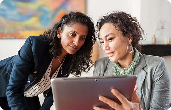 Two women looking at a tablet