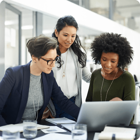 Employees gathered around a laptop